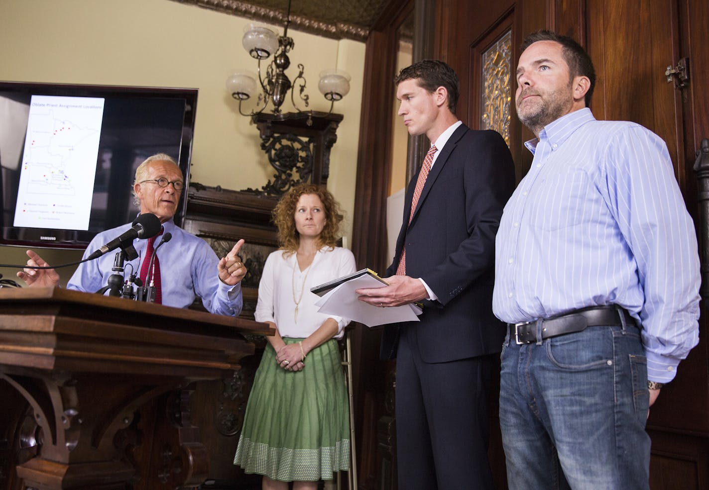 Joe McLean, right, a survivor of alleged abuse by a priest of the Oblates of Mary Immaculate, speaks during a press conference at the office of Jeff Anderson & Associates in St. Paul on Tuesday, July 7, 2015. McLean is joined by his wife Colleen McLean and attorneys Jeff Anderson, left, and Mike Finnegan, second from right. ] LEILA NAVIDI leila.navidi@startribune.com / BACKGROUND INFORMATION: The names and assignment histories of seven priests of the Oblates of Mary Immaculate who have been cred