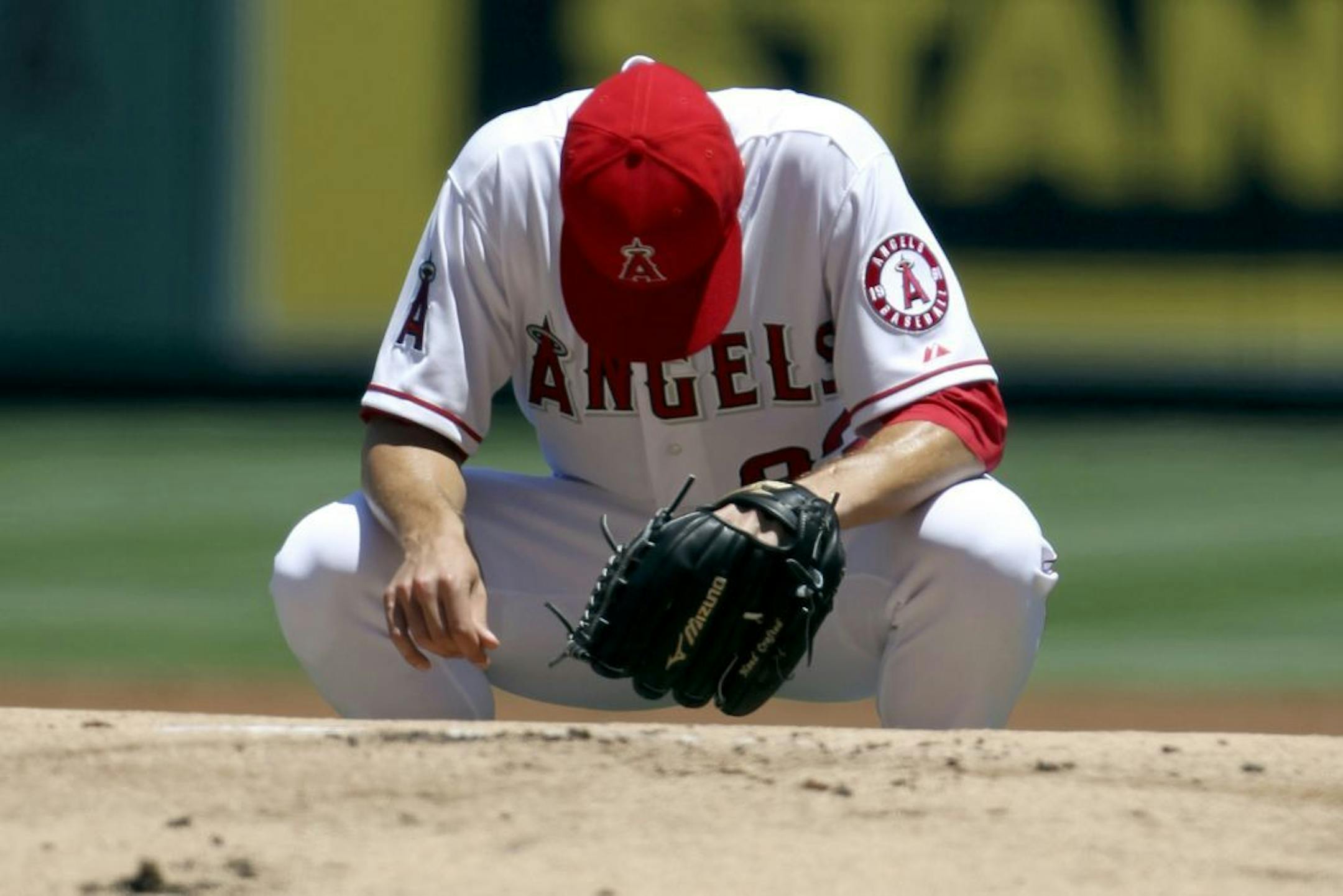 Los Angeles Angels starter Zack Greinke pauses a moment before his first pitch to the Tampa Bay Rays in the second inning of a baseball game in Anaheim, Calif., Sunday, July 29, 2012. Greinke made his debut with the Angels after being traded by the Milwaukee Brewers.
