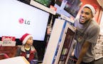 Timberwolves center Karl-Anthony Towns shops with Jaidon Jackson, 8, of Rosemount, whose father is in the Minnesota Army National Guard, during their 
