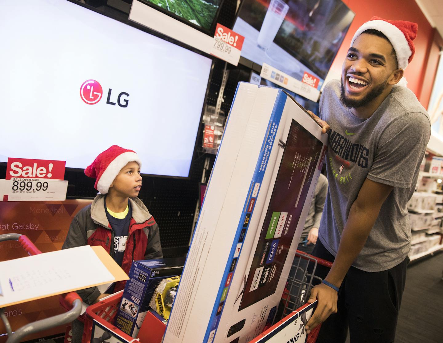 Timberwolves center Karl-Anthony Towns shops with Jaidon Jackson, 8, of Rosemount, whose father is in the Minnesota Army National Guard, during their annual Holiday Shopping for Kids in December of 2017.