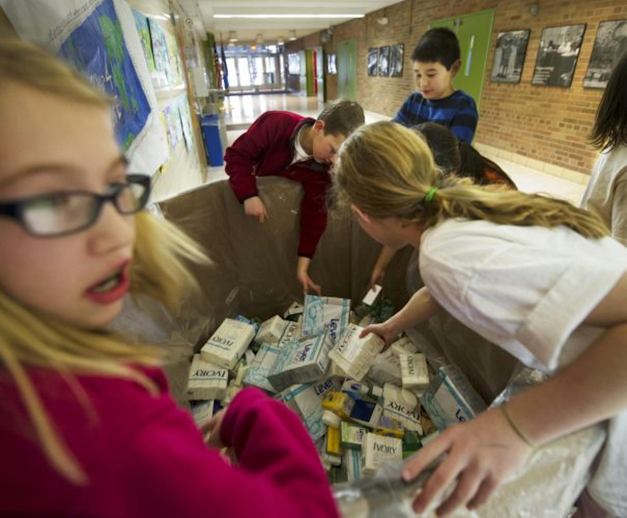Packing up soap were, from left, Highlands Elementary students Kylie Imholte, Carter Theis, David Ha, Ashley Mei and Abby Mans.