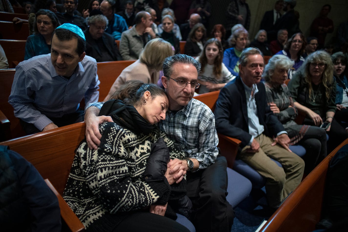 Joel Glaser, holding his partner Jethra, attended a memorial at Temple Israel for the injured and eleven who died over the weekend in a synagogue in Pittsburgh.