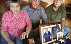 Elaine Bain and her sons Dick and Jim Bain, pose withe pictures of her son Jerry Bain, who died of a drug overdose at the Minneapolis Veterans Home. ]