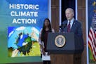 President Joe Biden speaks in the South Court Auditorium on the White House complex in Washington Nov. 14, 2023, about climate change, as Ritika Shah,