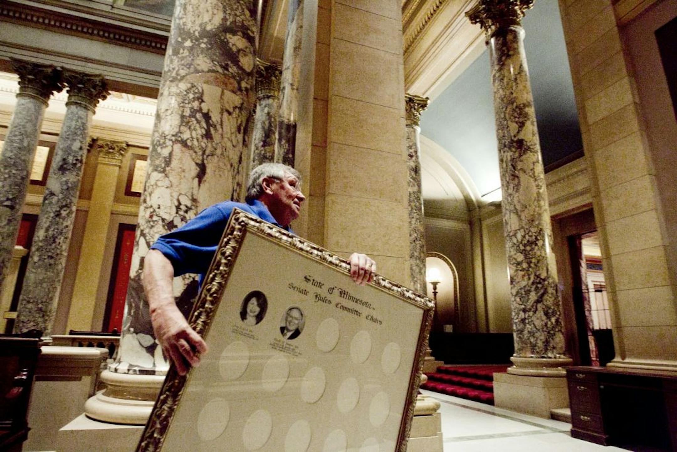 Workers hustled with finishing touches on Monday outside the Senate chambers at the State Capitol in St. Paul. The 2012 session convenes on Tuesday.