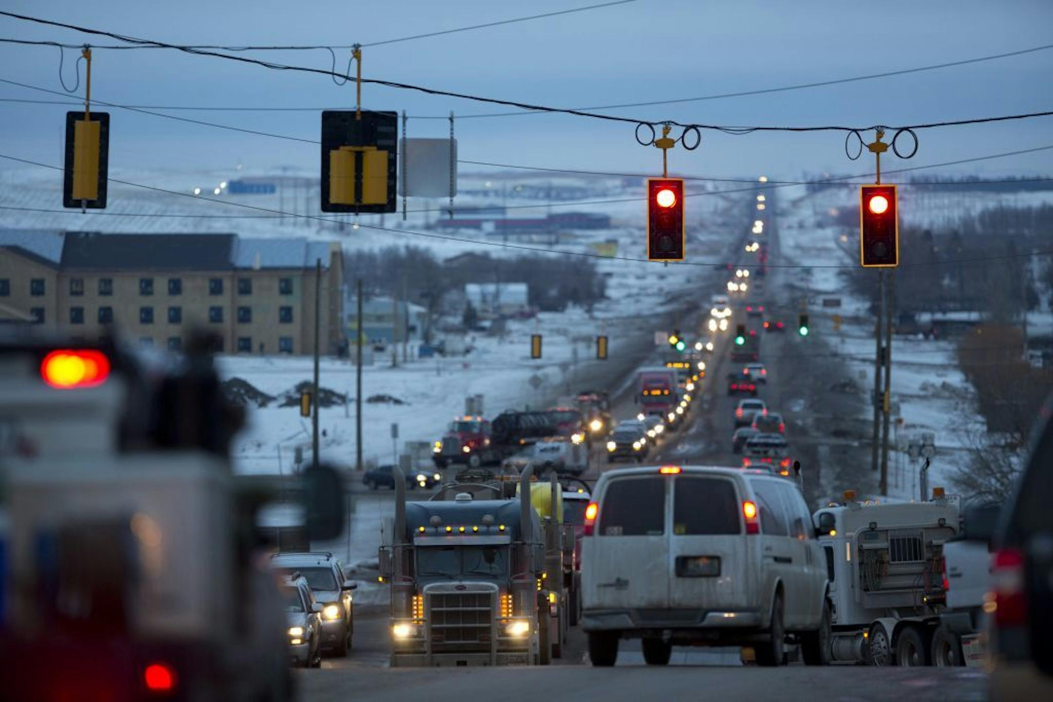 Work in the Bakken Oil Fields of North Dakota has brought an influx of thousands or workers, making North Dakota the fastest growing state in America. Late afternoon traffic coming and going from Watford City, ND Wednesday, January 16, 2013. The oil boom has seen the town grow from about 1700 people in 2010 to perhaps 10,000 today.