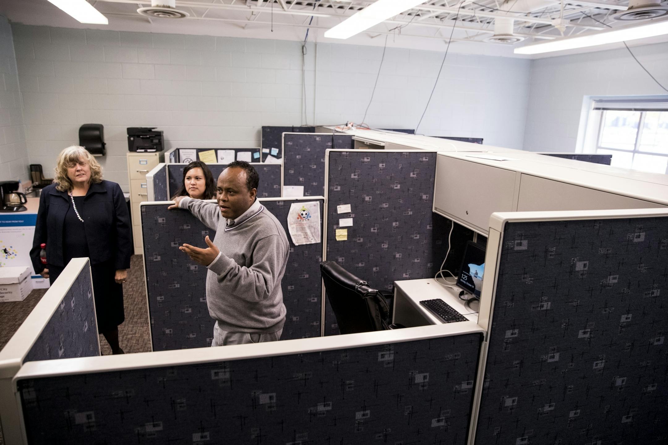 Bekel Adamu stood in his cubicle that is set up in a classroom at the Brian Coyle Center along with six other desks that all deal with different social services on Monday, October 24, 2016, in Minneapolis, Minn.