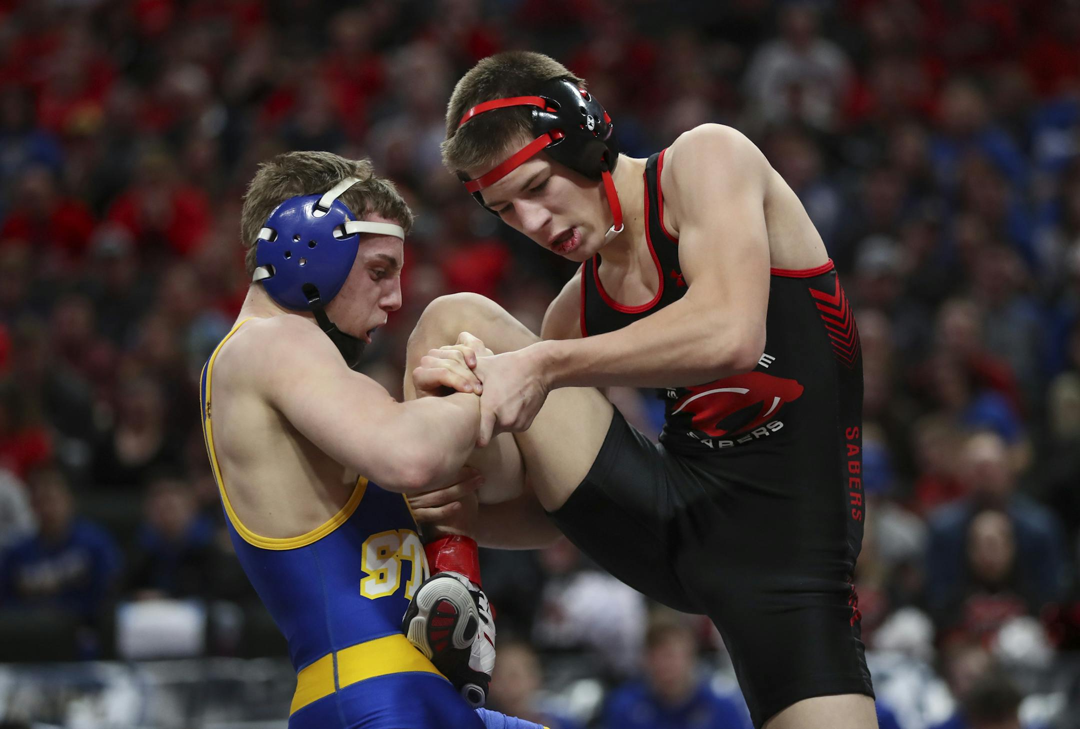 Brandon Psyk of St. Michael-Albertville, left, made a move on Shakopee's Ben Lunn during their 113lb. match in Class 3A competition. Psyk of St. Michael-Albertville won 9-5. ] JEFF WHEELER ï jeff.wheeler@startribune.com The State High School Wrestling Tournament team competition Championship took place Thursday night, March 1, 2018 at Xcel Energy Center in St. Paul.