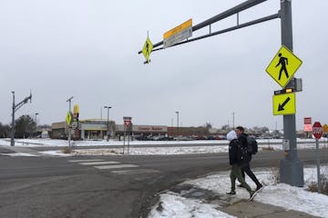 St. Francis High School students JP Krage, 14, and Tyler Forcier, 15, cross Hwy. 47 after school in December, near where two middle school students we