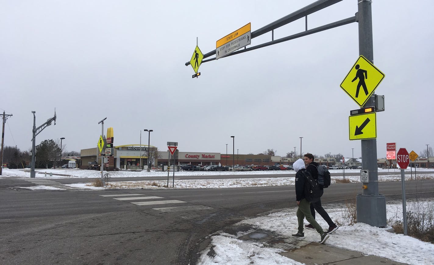 St. Francis High School students JP Krage, 14, and Tyler Forcier, 15, cross Hwy. 47 after school in December, near where two middle school students were hit and injured in November.