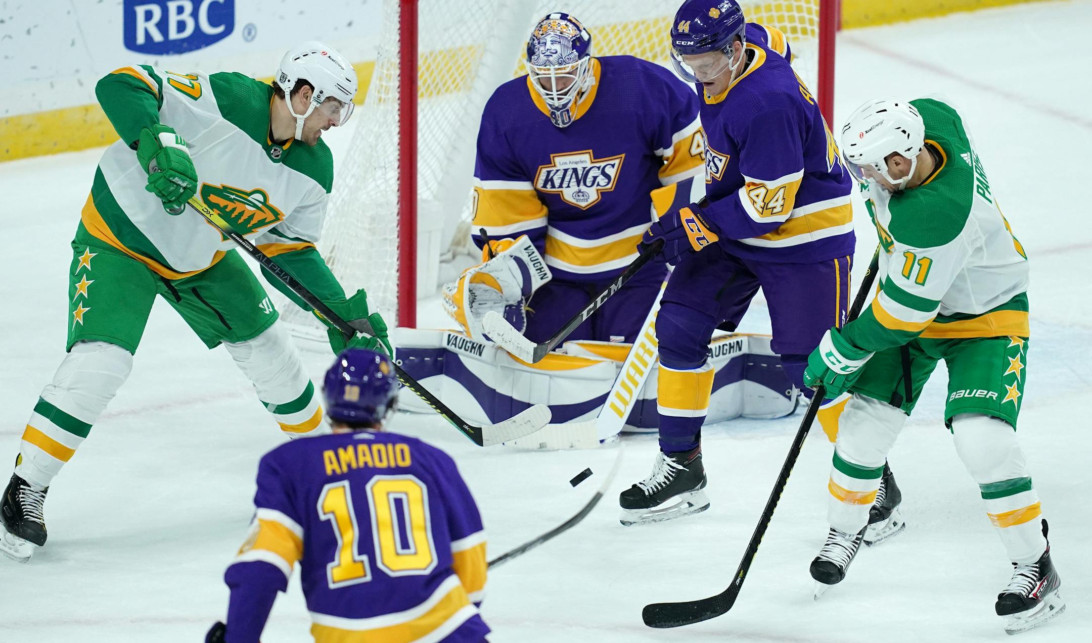 Minnesota Wild left wing Marcus Foligno tried to get the puck from Los Angeles Kings defenseman Mikey Anderson as he looked to clear it in the first period.
