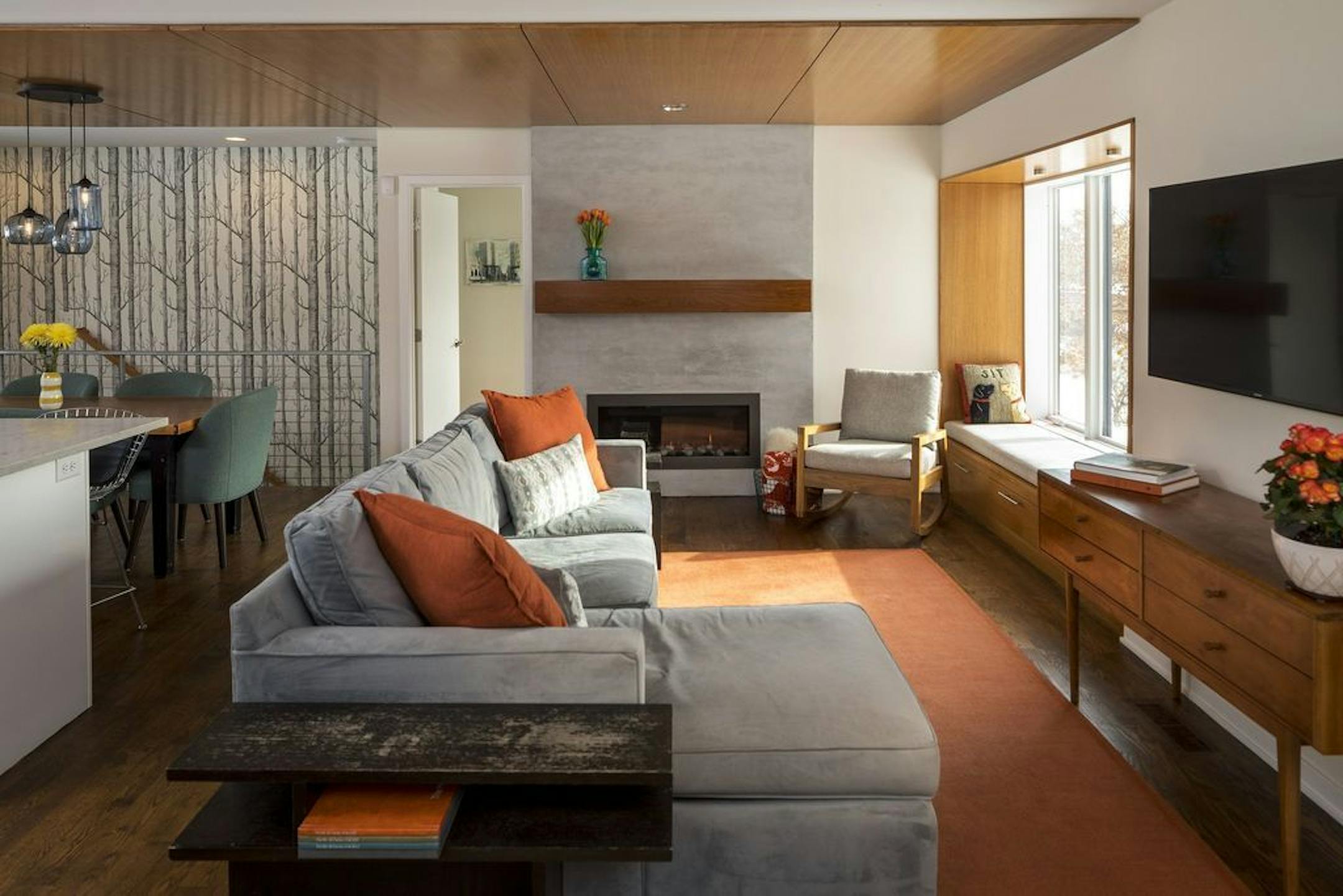 Twin bay windows (one on each end of the main floor) add sitting spots in the opened-up living spaces. A heavy brick wood burning fireplace was replaced with a streamlined gas fireplace.