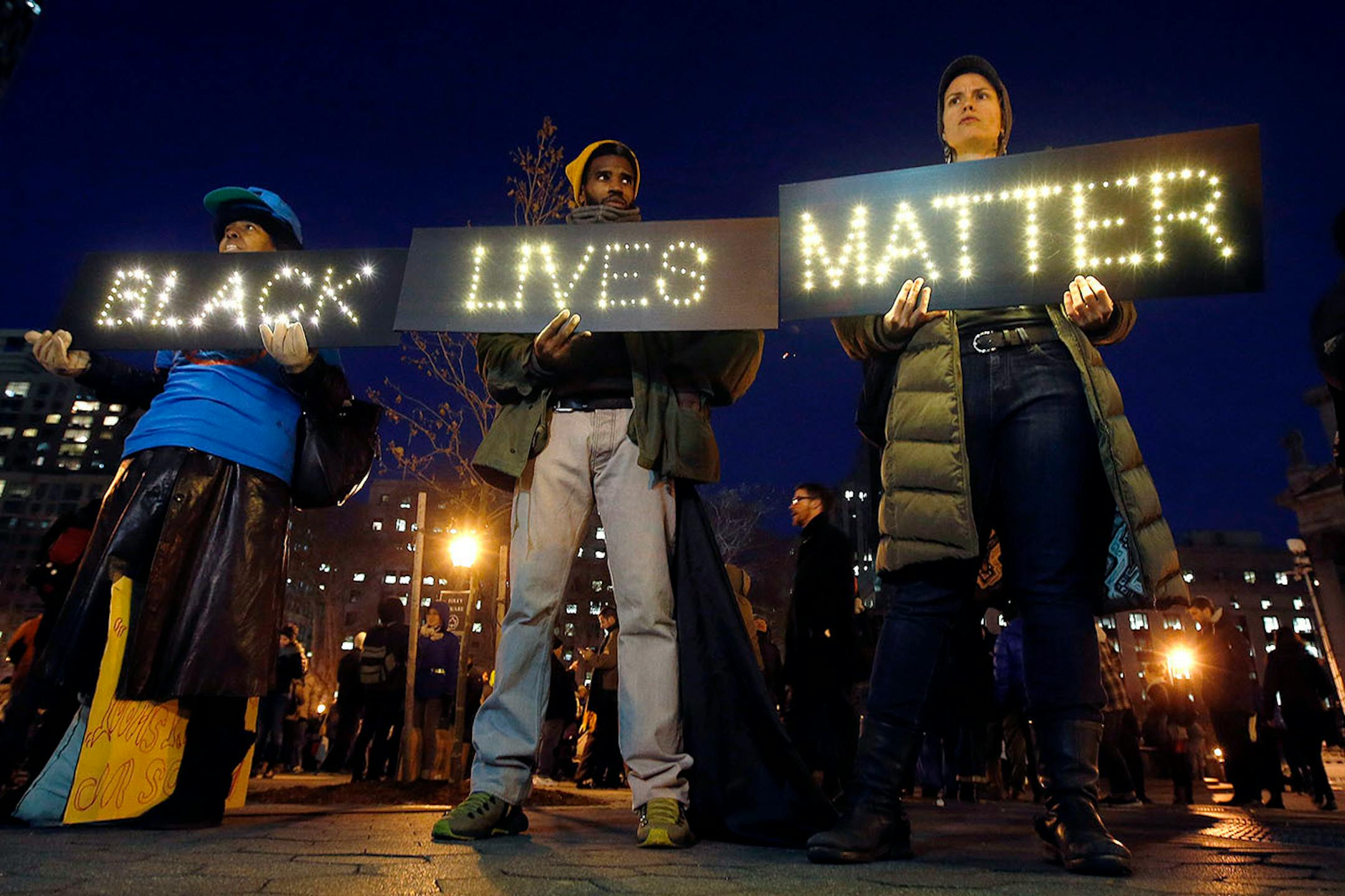 Protesters rallying against a grand jury's decision not to indict the police officer involved in the death of Eric Garner gather in Foley Square, Thursday, Dec. 4, 2014, in New York. (AP Photo/Jason DeCrow)