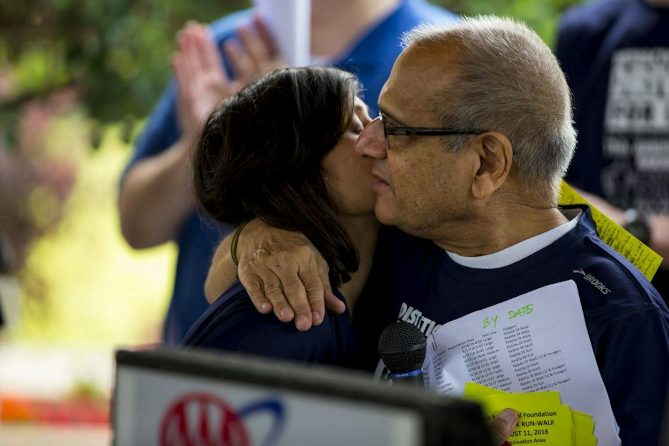Nayha Dixit embraces her father, Vijay, at the Raksha 5K Walk/Run to End Distracted Driving on Aug. 11, 2018. His latest effort is a 2020 wall calendar that features colorful anti-distracted driving sketches by kids.