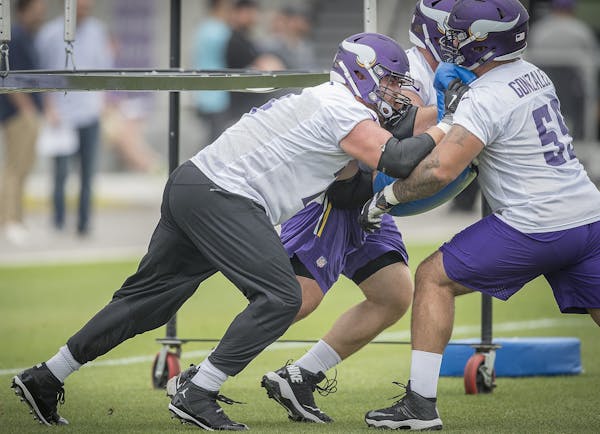 Vikings tackle Mike Remmers, left, took part in minicamp at the TCO Vikings Performance Center