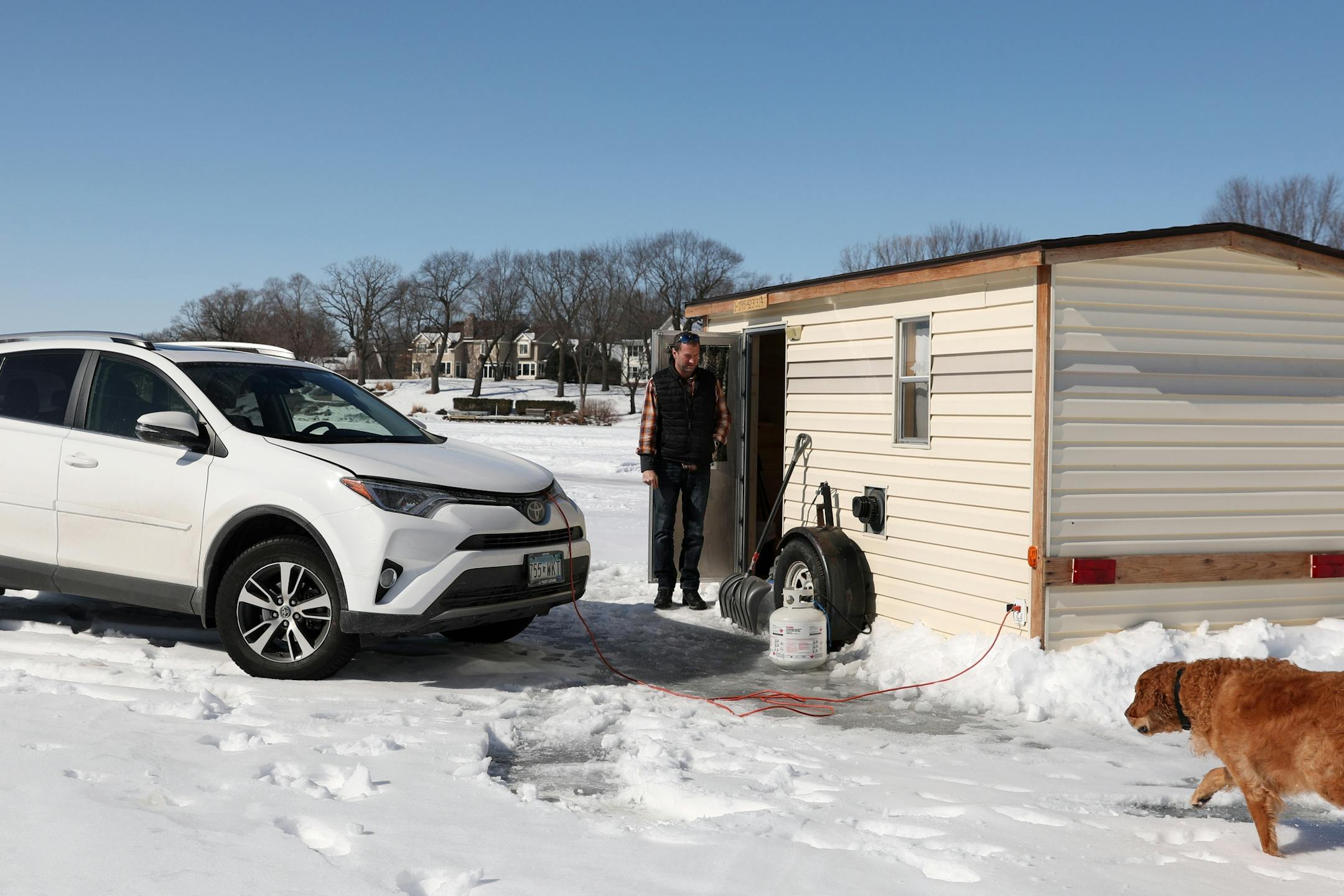 Darrin Stuhr of Eden Prairie called his dog Baylor, a 4-year-old golden retriever, back into his ice fishing shelter Thursday at Lake Minnetonka.