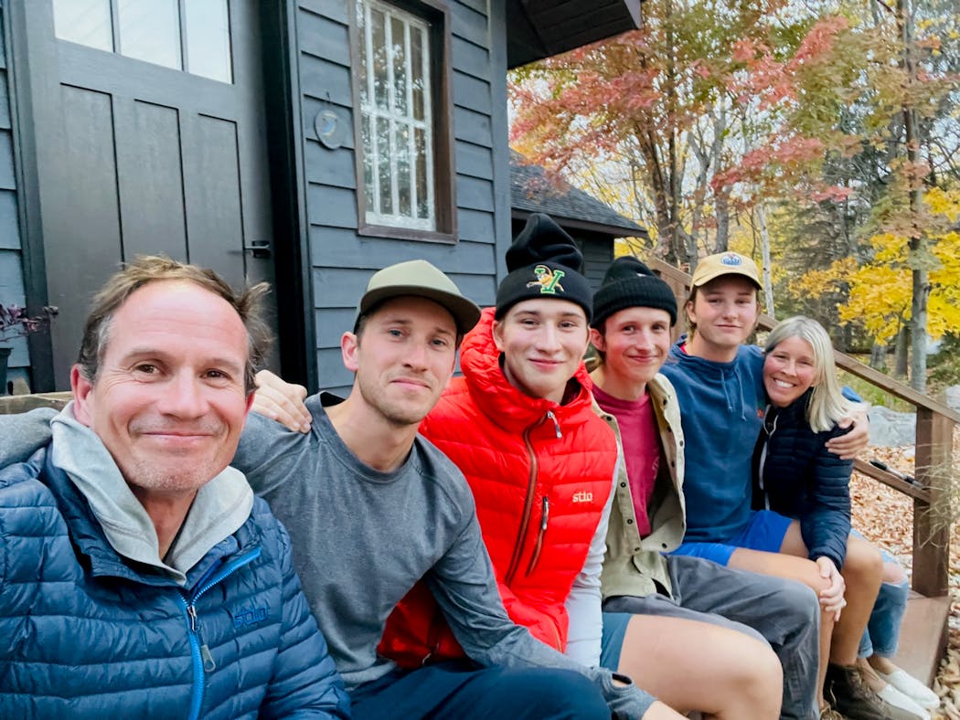 Maplelag Resort owners Jay and Jonell Richards with their four sons — Jake, Jens, Jack and Jon — on Oct. 10, 2022, while firefighters worked to extinguish a fire at the resort’s main lodge.