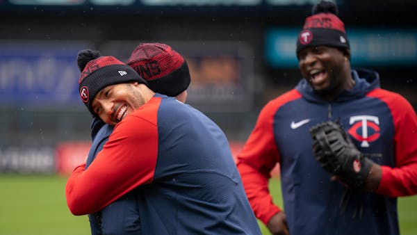 Carlos Correa hugged a teammate as Miguel Sano looked on during the Twins’ workout at Target Field on Wednesday.