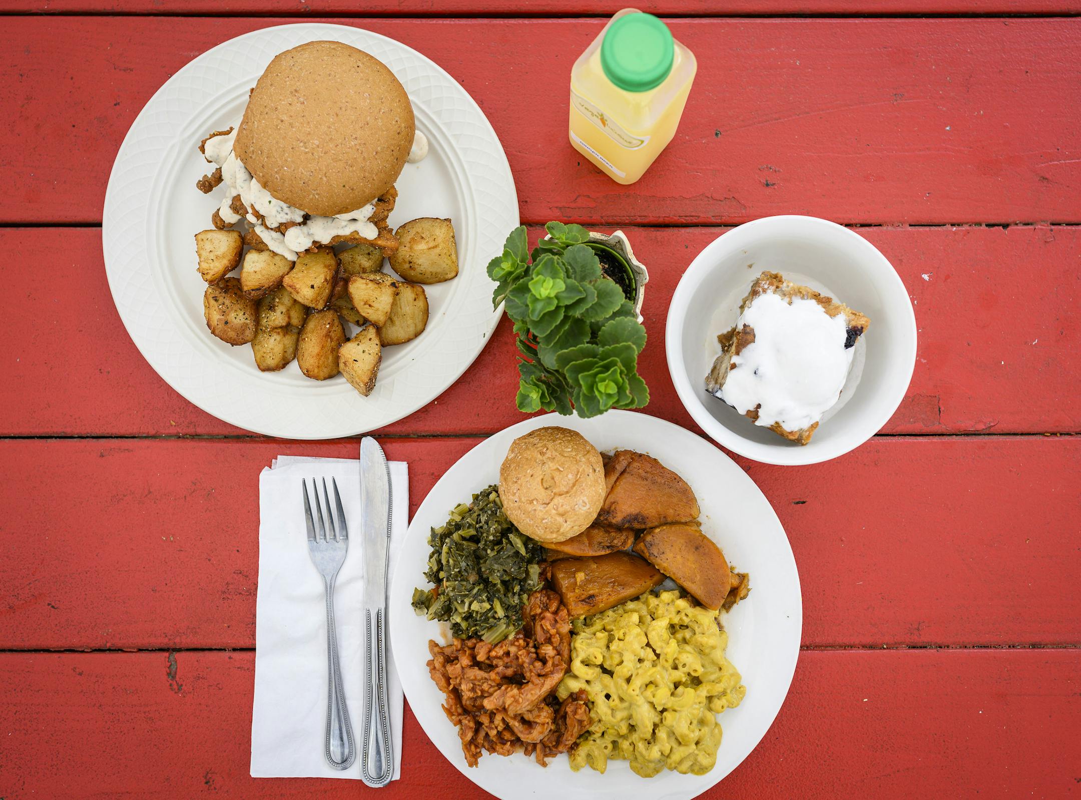 Dishes at Vege-licious, including a vegan chicken sandwich; barbecue chicken with yams, collard greens, vegan mac and cheese; and bread pudding in Nashville, Tenn., Oct. 30, 2019. The city once famed for meat-and-threes has a new culinary scene expanding in different directions, including widespread vegan dishes and all-vegan establishments. (William DeShazer/The New York Times)
