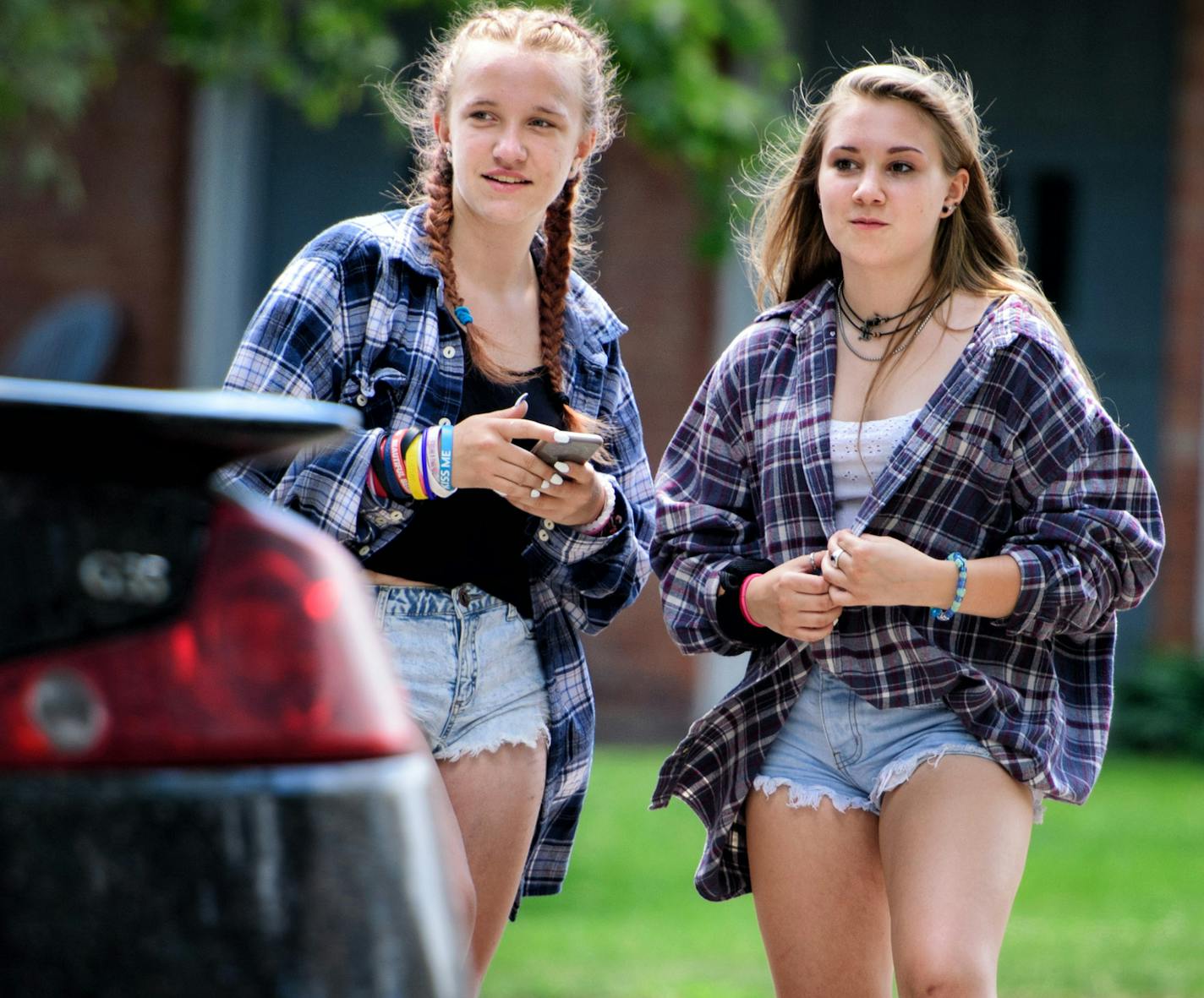 Chloe Bennett, 14 and her friend Haley Klun, 15, checked out the young occupants of black Infiniti that drove slowly through the Hopkins neighborhood. ] GLEN STUBBE * gstubbe@startribune.com Thursday, June 30, 2016 Chloe Bennett, 14 and her friend Haley Klun, 15 are hanging out at their usual time to explore the woods and take pictures near Chloe's home in Hopkins. Chloe, 14, waited too long to find a summer job so she said she's often bored. "It's hard to find stuff to do," she said. "The days