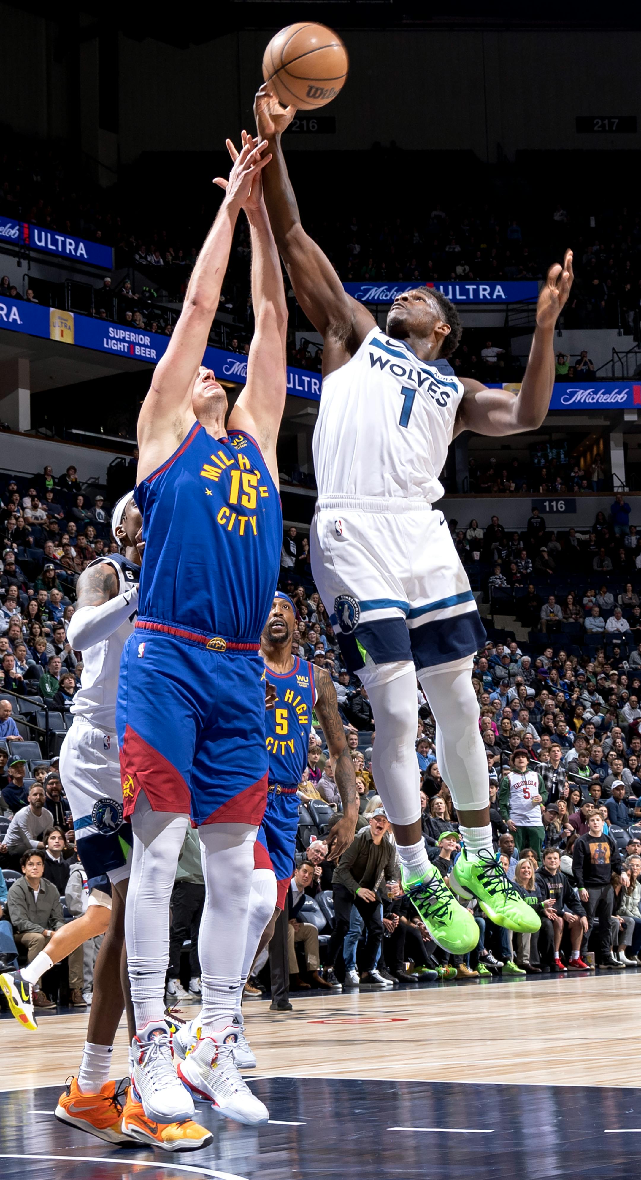 Anthony Edwards (1) of the Minnesota Timberwolves fights for the ball with Nikola Jokic (15) of the Denver Nuggets in the first quarter.