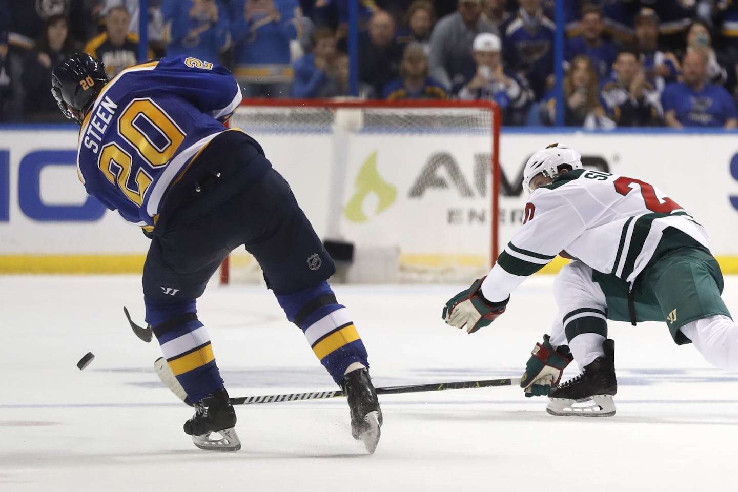 St. Louis Blues' Alexander Steen, left, scores on an empty net as Minnesota Wild's Ryan Suter watches during the third period in Game 3.