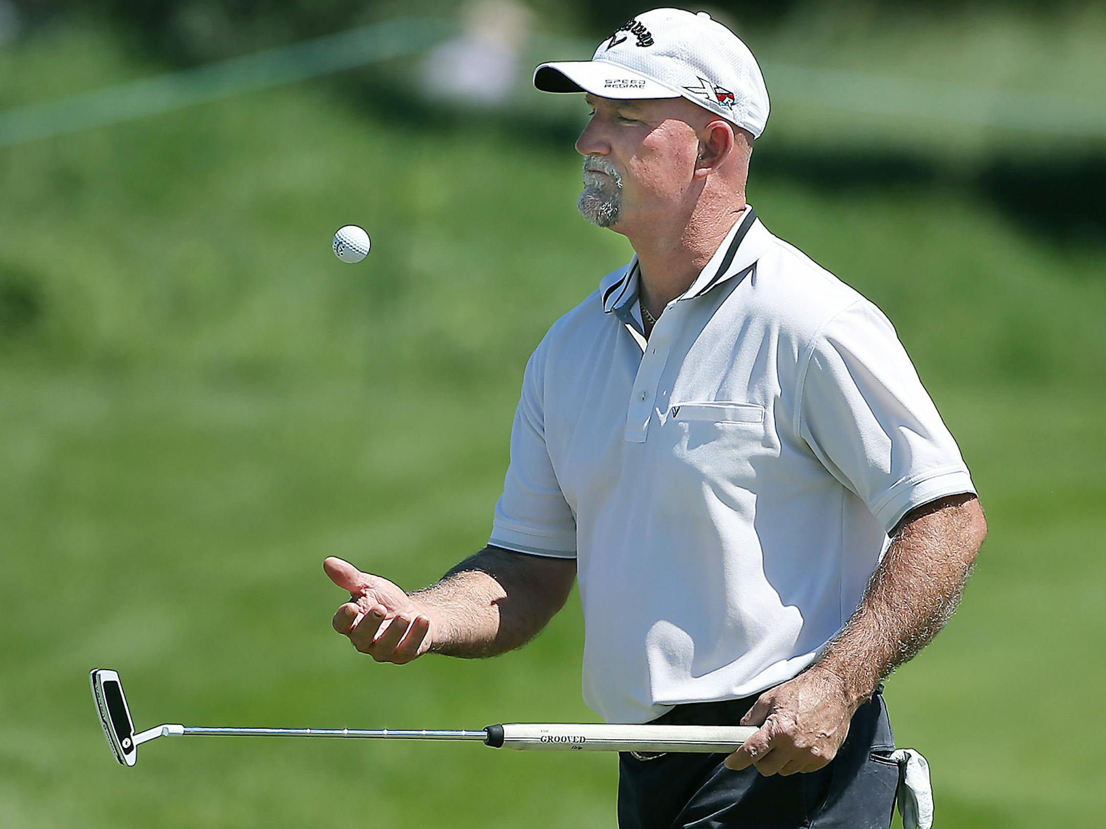 Marco Dawson tossed the golf ball into the air on the 6th green during the Pro-Am at the 3M golf tournament at TPC Twin Cities, Thursday, July 30, 205 in Blaine, MN. ] (ELIZABETH FLORES/STAR TRIBUNE) ELIZABETH FLORES &#x2022; eflores@startribune.com