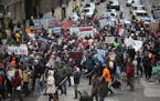 Photos by KYNDELL HARKNESS &#xef; kyndell.harkness@startribune.com Protesters marched through downtown Minneapolis on their way to the Hennepin County