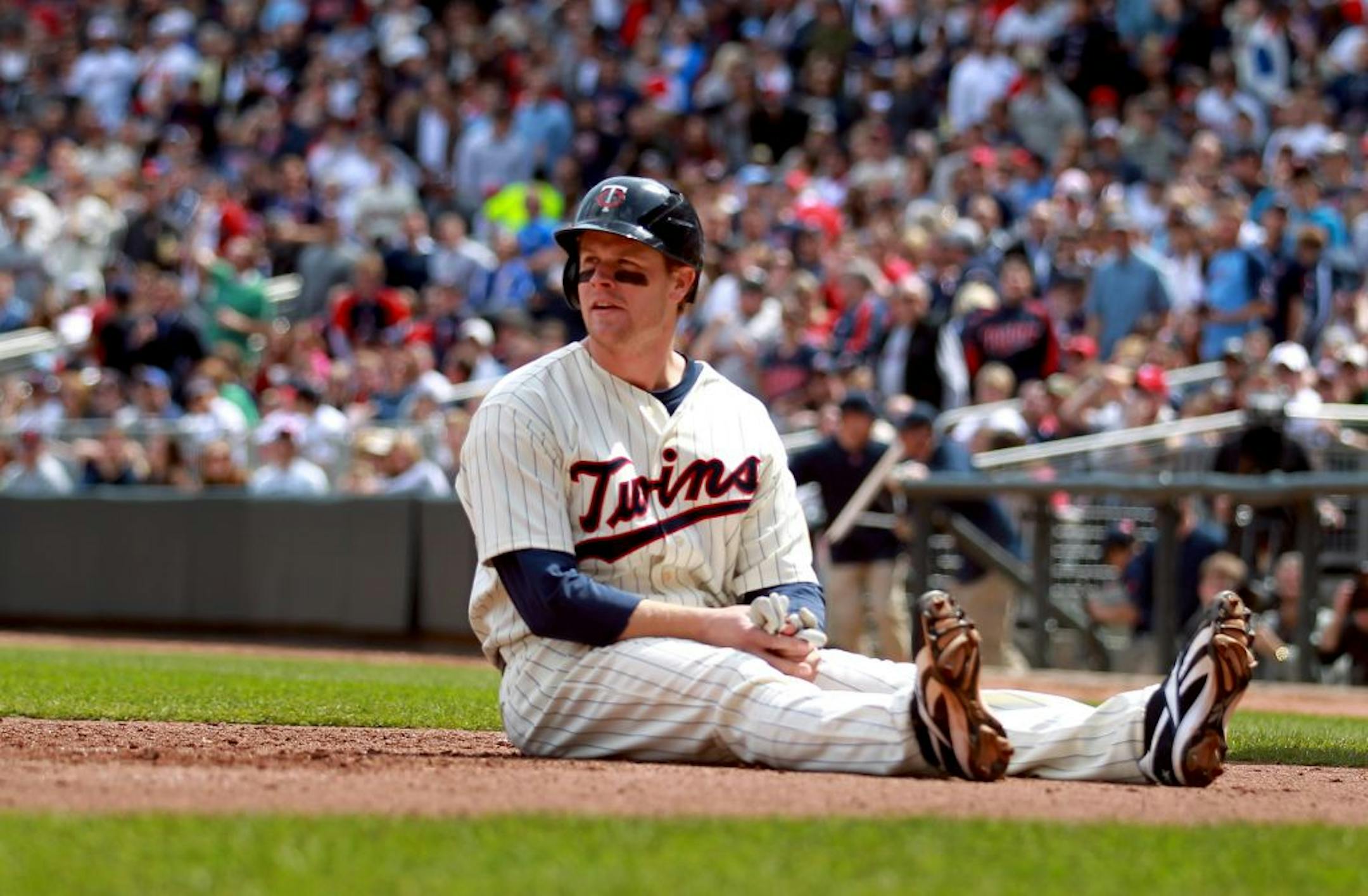 Twins first baseman Justin Morneau sat on the plate at home after he was tagged out in a recent game.