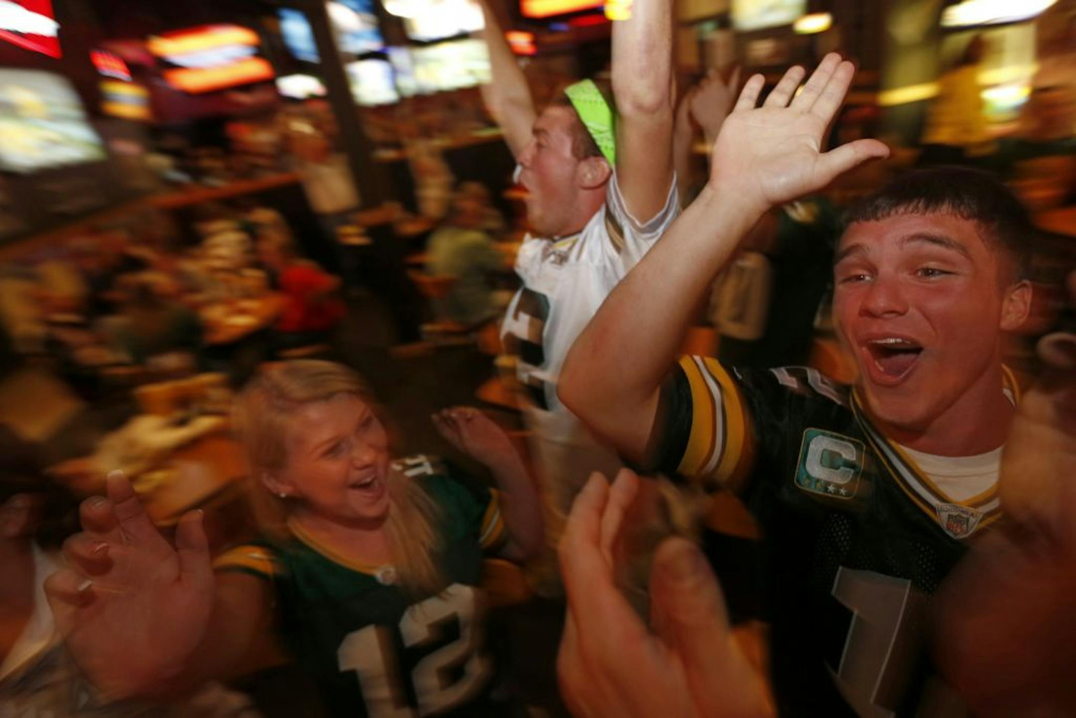 At the Buffalo Wild Wings in Hudson, Wisconsin, Nicole Mischlar, Josh Schneider, and Kyle Rentmeester rooted for the Packers in a Thursday night game against the bears .