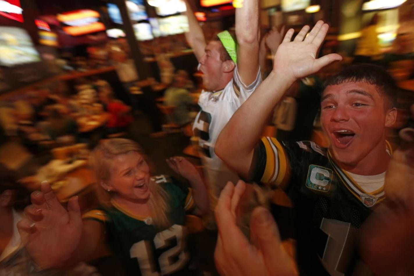 At the Buffalo Wild Wings in Hudson, Wisconsin, Nicole Mischlar, Josh Schneider, and Kyle Rentmeester rooted for the Packers in a Thursday night game against the bears .