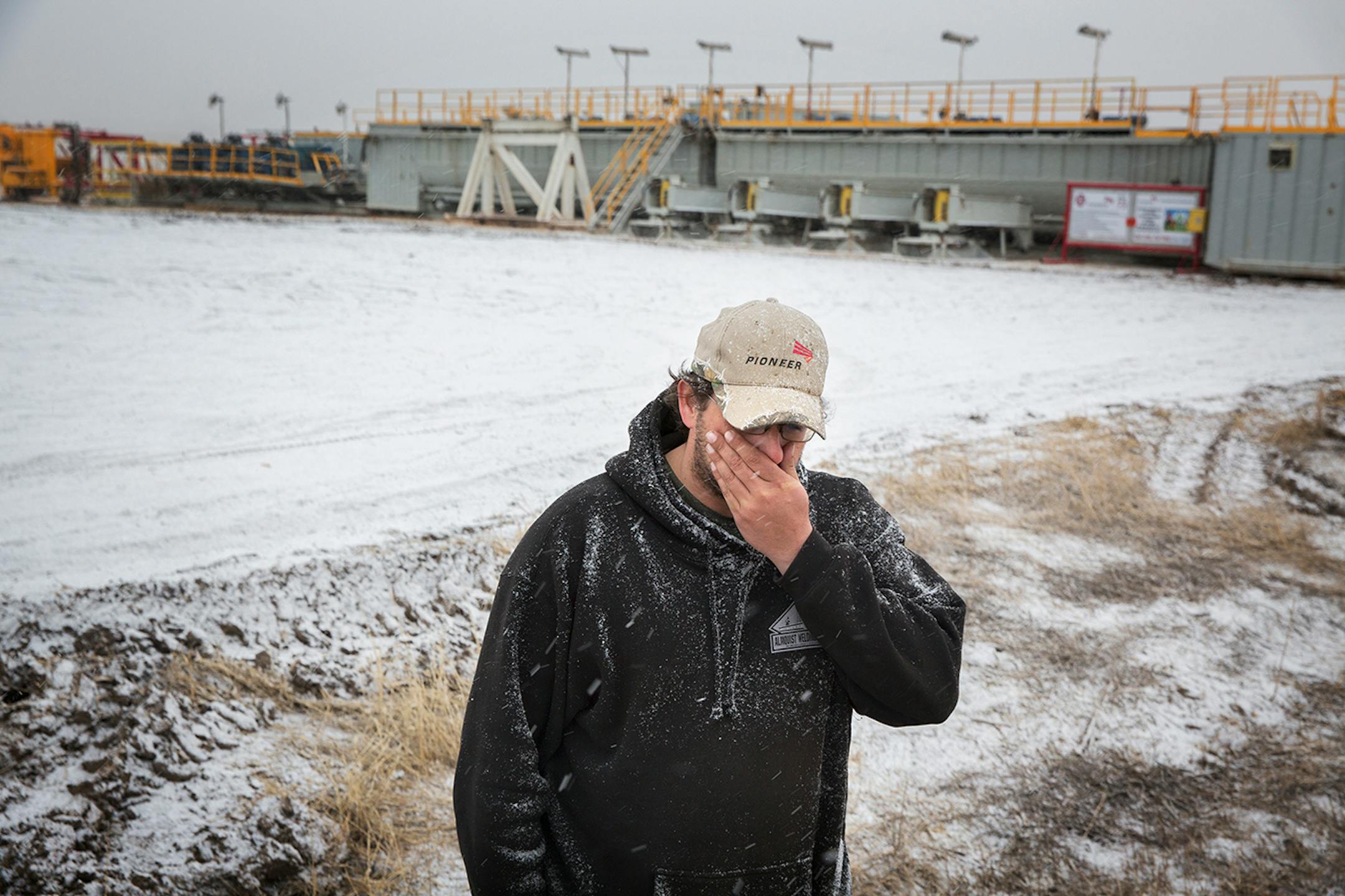 Shay Hunt lost his job working a Pioneer oil rig when it shut down, and now has a job guarding the rig at night in the outdoor storage location west of Williston, North Dakota on Friday, April 3, 2015.