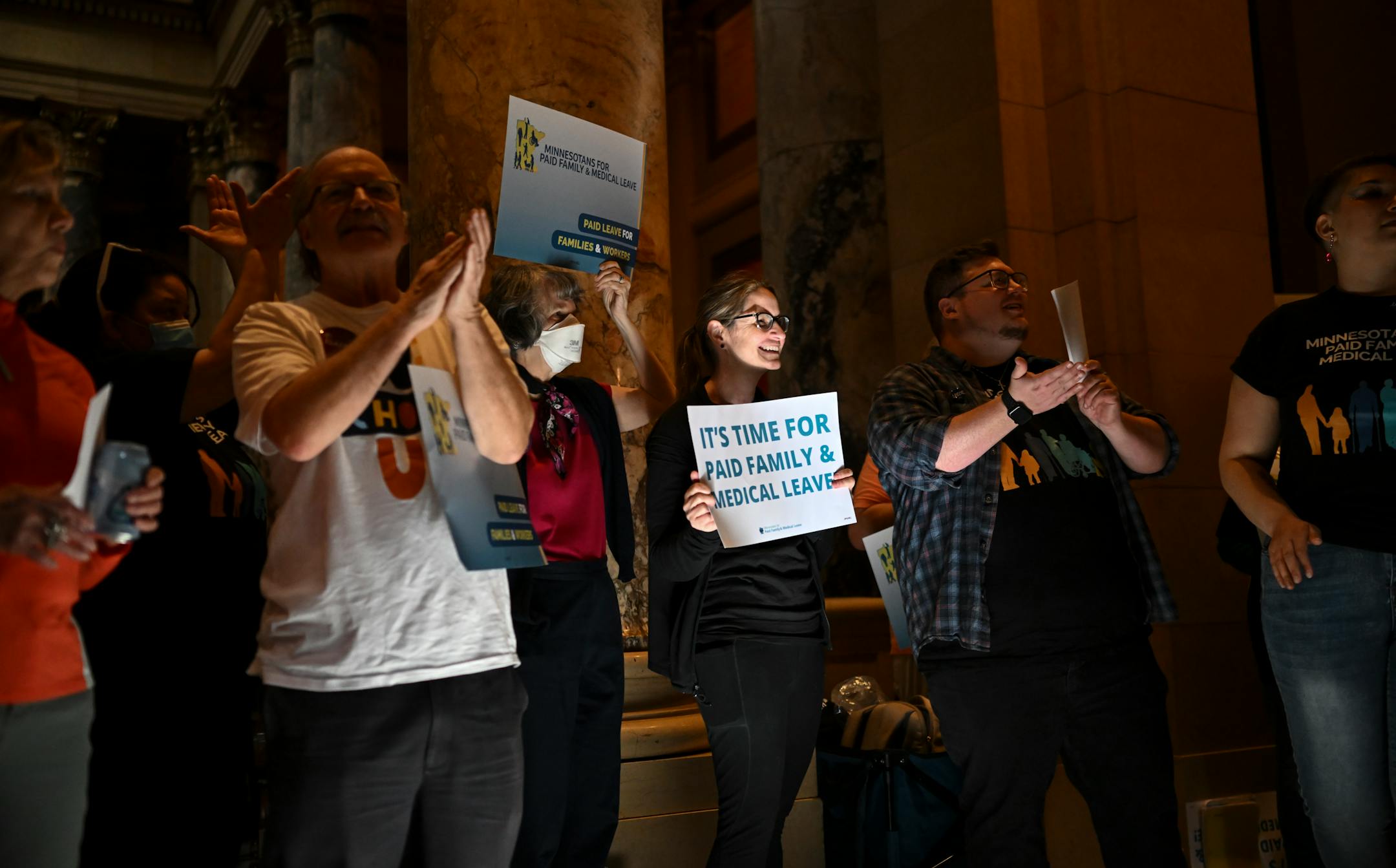 Paid family leave advocates gather for a rally Monday at the Minnesota State Capitol.