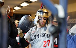 The Twins' Ryan Jeffers wears a sign of his success after he hit a home run Saturday night against the Brewers.
