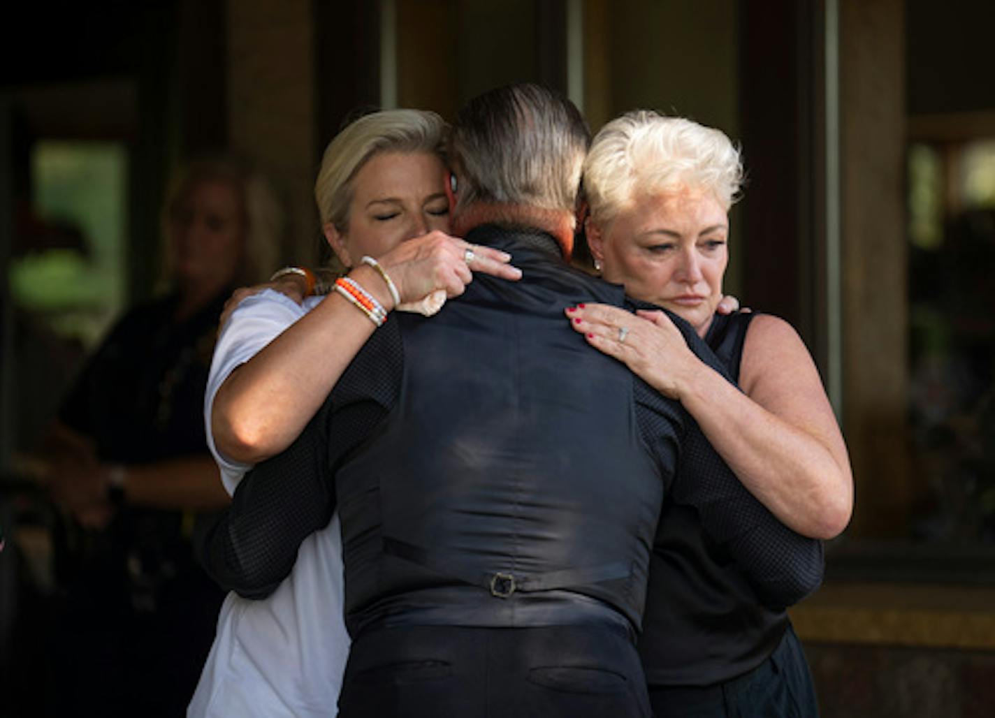 Two women embraced Stephen Lund, a friend of the Schuman family, after he talked about him on their behalf outside the celebration of Isaac Schuman's life Tuesday afternoon, August 16, 2022 at the Oak Glen Event Center in Stillwater, Minn. Schuman died as a result of being stabbed after a confrontation while floating with friends down the Apple River in Somerset, Wisc. ] JEFF WHEELER • Jeff.Wheeler@startribune.com