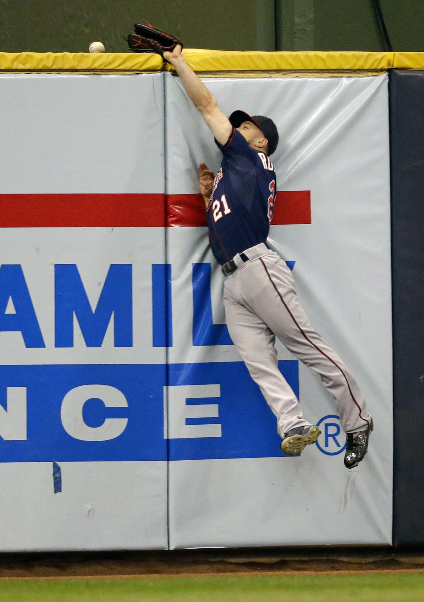 Minnesota Twins' Shane Robinson cannot catch a home run by Milwaukee Brewers' Gerardo Parra during the first inning of a baseball game Friday, June 26, 2015, in Milwaukee. (AP Photo/Jeffrey Phelps)