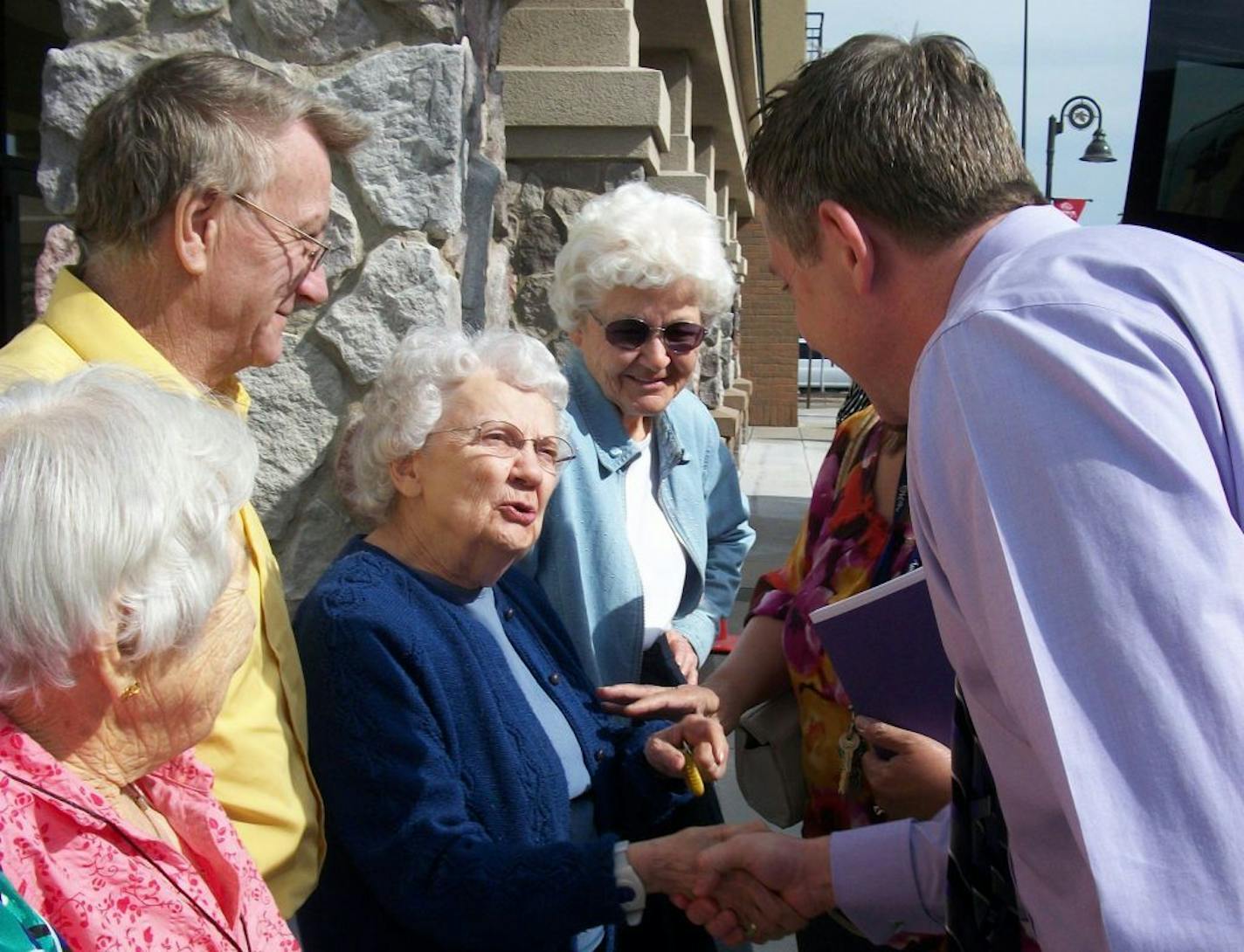 Joel Theisen, CEO of senior care services company Lifesprk, meets with a group of seniors.