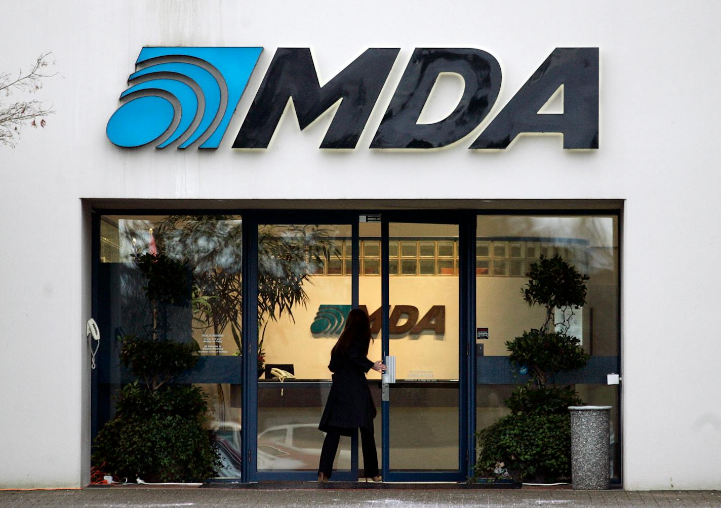 A woman entered the offices of MacDonald, Dettwiler and Associates Ltd. near Ottawa, this winter. On Thursday Canada blocked Alliant Techsystems' purchase of the company that built the Canadarm that has been used for years for robotic work on the International Space Station .