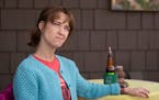 Comedian Mary Mack with a gluten-free beer on the deck in the back yard of her Minneapolis home.