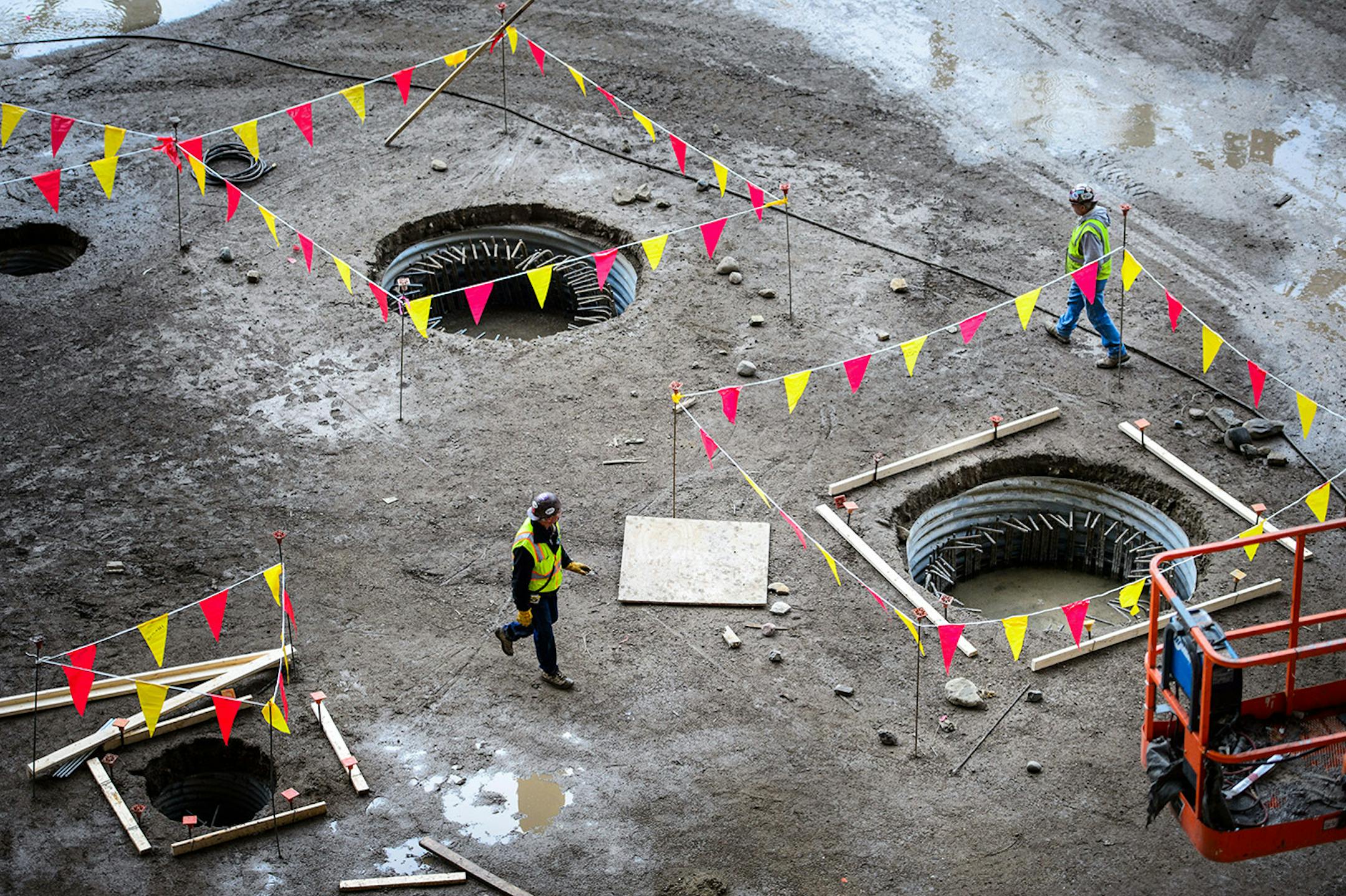 The new Vikings stadium under construction. Workers stepped around muddy puddles and drainage holes. Thursday, May 14, 2015 Construction update of the new Vikings stadium, Minneapolis, MN