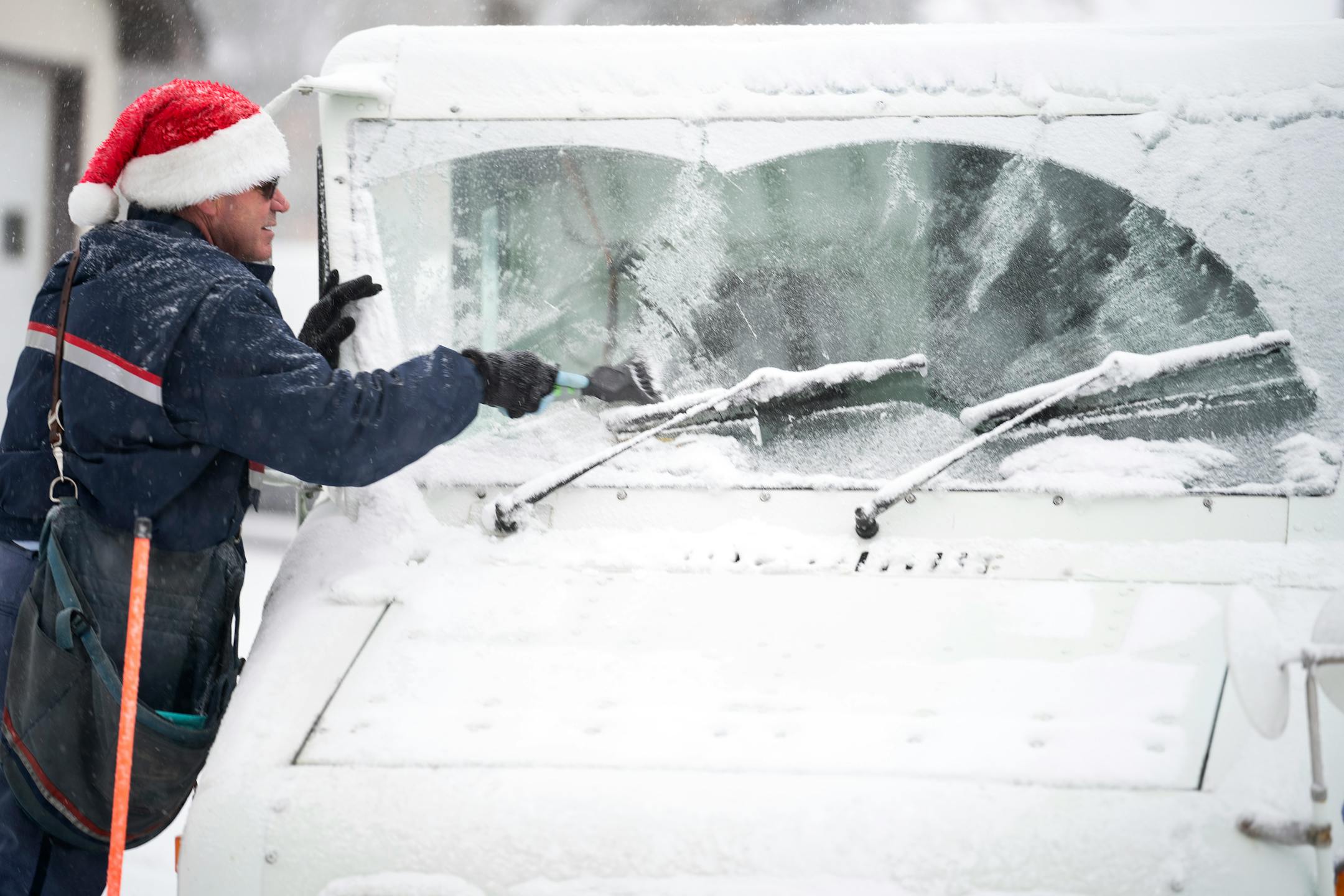 Osseo mail carrier Dennis Niles braved the blowing  snow as blizzard like conditions hit Osseo and the Twins Cites on Wednesday, 5-9 inches of snow as expected.