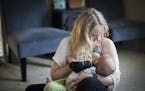 Ariel Landsberger held her son Sonney as she attempted to breastfeed him at their home in Minneapolis, Minn., on Tuesday, November 4, 2014. The young 