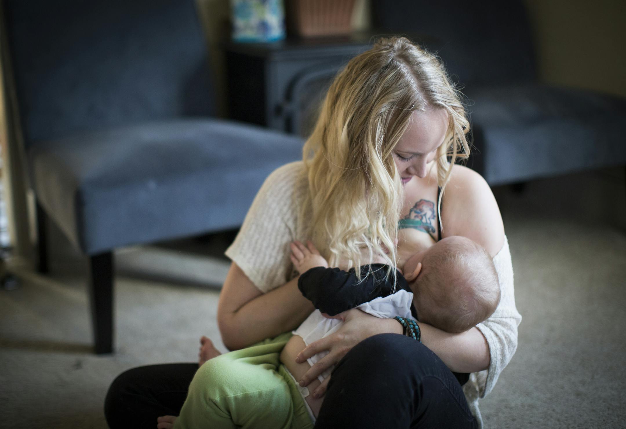 Ariel Landsberger held her son Sonney as she attempted to breastfeed him at their home in Minneapolis, Minn., on Tuesday, November 4, 2014. The young Minneapolis mom started a social media campaign on Instagram to normalize breastfeeding in public a few months ago. ] RENEE JONES SCHNEIDER ¥ reneejones@startribune.com