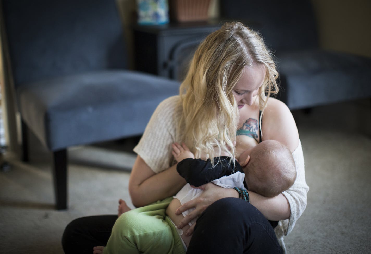 Ariel Landsberger held her son Sonney as she attempted to breastfeed him at their home in Minneapolis, Minn., on Tuesday, November 4, 2014. The young Minneapolis mom started a social media campaign on Instagram to normalize breastfeeding in public a few months ago. ] RENEE JONES SCHNEIDER &#xa5; reneejones@startribune.com