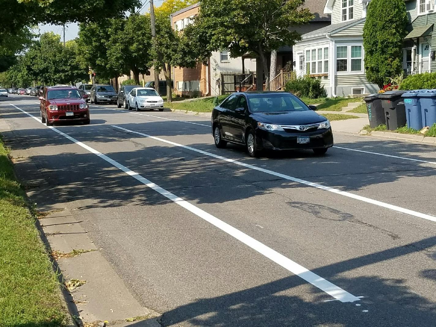 A Jeep is driven in the buffer zone on W. 28th Street at Colfax Ave. The 8-foot buffer zone is not a traffic lane. Photo by Tim Harlow.