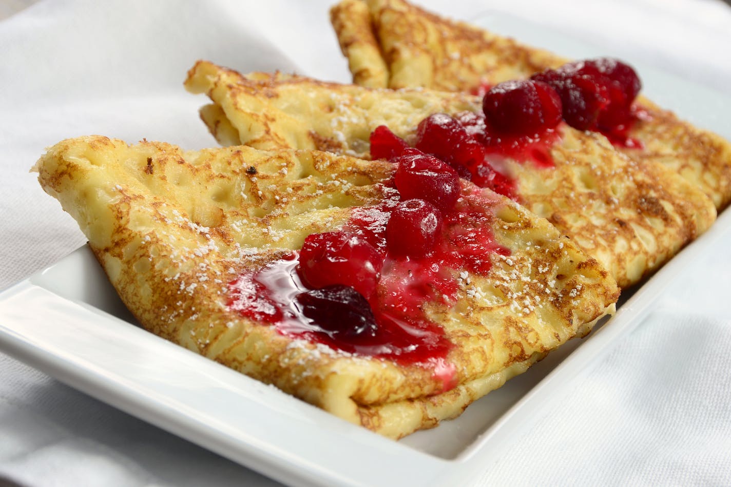 Homemade Swedish pancakes with berry compote.