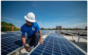 An IPS Solar installer worked at the Edina Public Works Community Solar Garden in 2019.