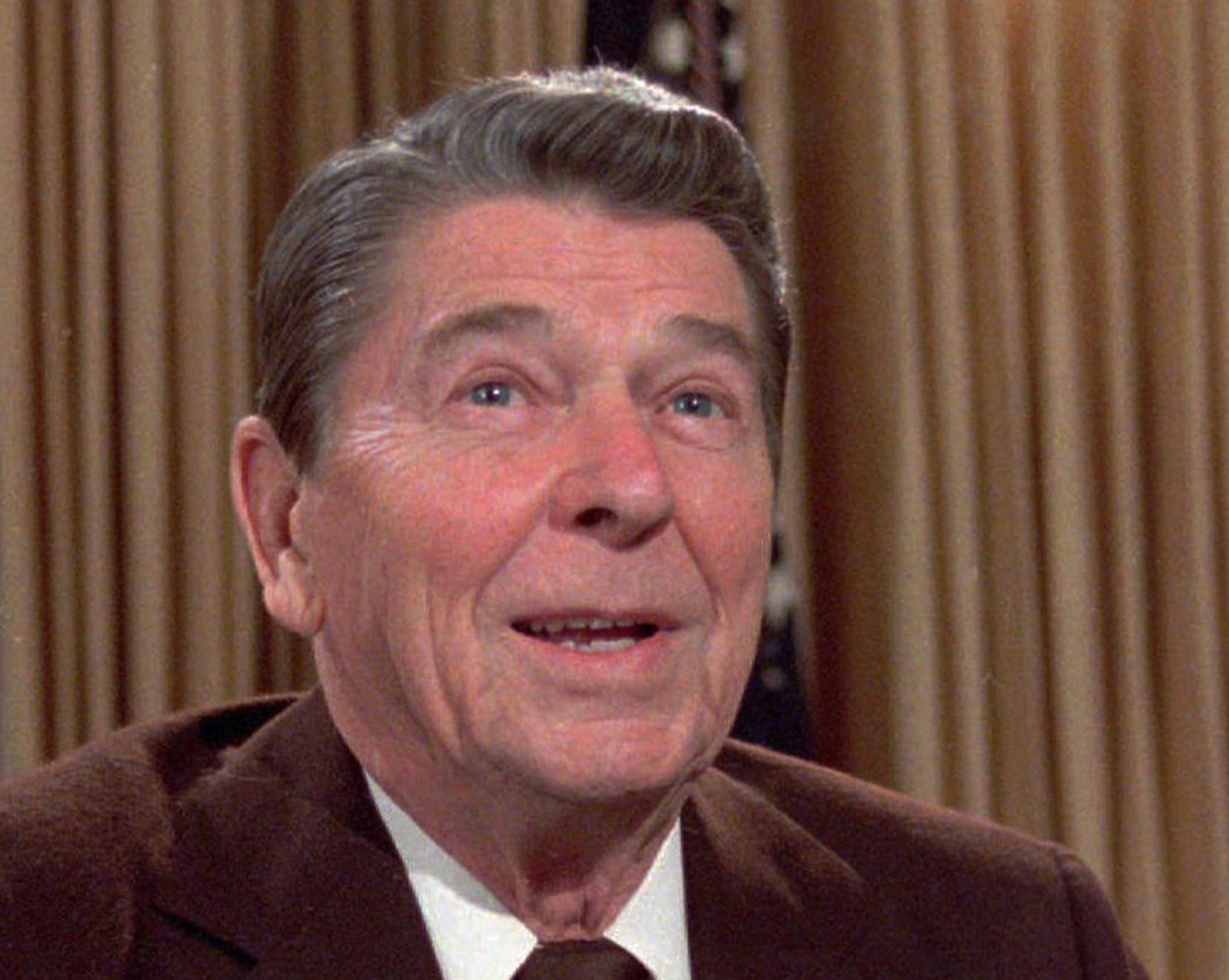 FILE - In this May 24, 1985, file photo, then U.S. President Ronald Reagan works at his desk in the oval office of the White House as he prepares a speech on tax revision. Age has long been an issue for politicians. Reagan faced plenty of questions about his mental abilities when he ran for U.S. president in 1980, and he was just 69 years old. Now Mahathir Mohamad, 92, is Malaysia's newest prime minister. It's been 37 years since Mahathir first had the job, and 15 since he retired from it. (AP P