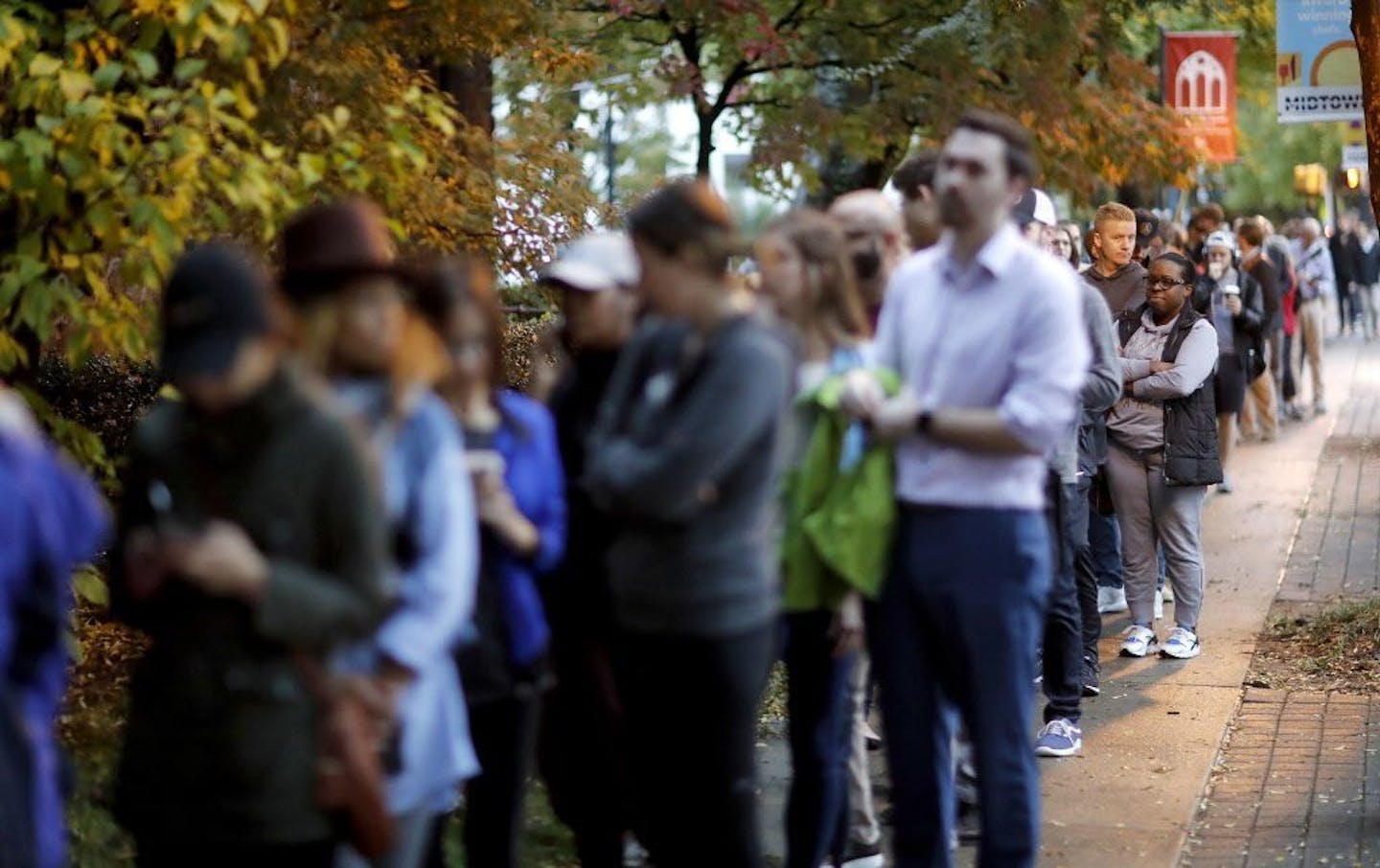 A line forms outside a polling site on election day in Atlanta, Tuesday, Nov. 6, 2018.