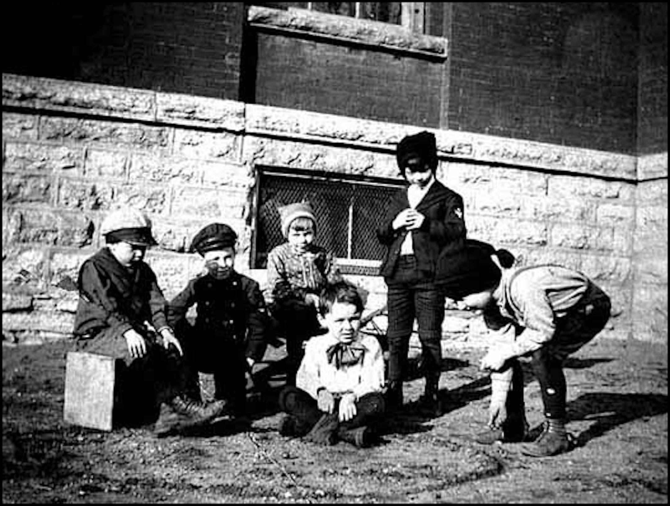 Playing marbles outside a grade school in Anoka in about 1904.